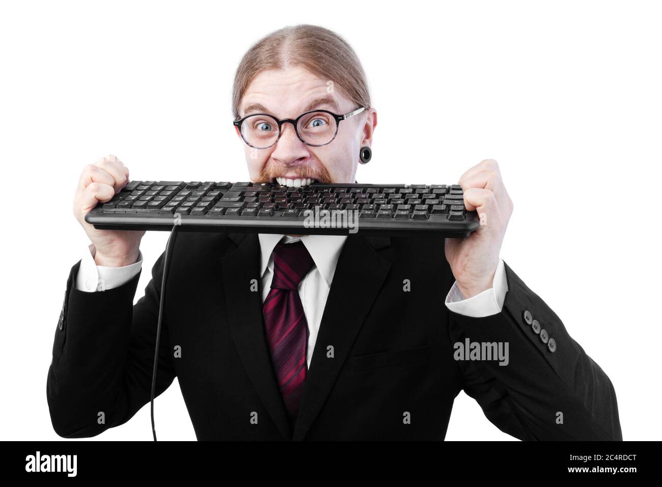 Angry Businessman With Long Tied Back Hair and Glasses Biting Keyboard