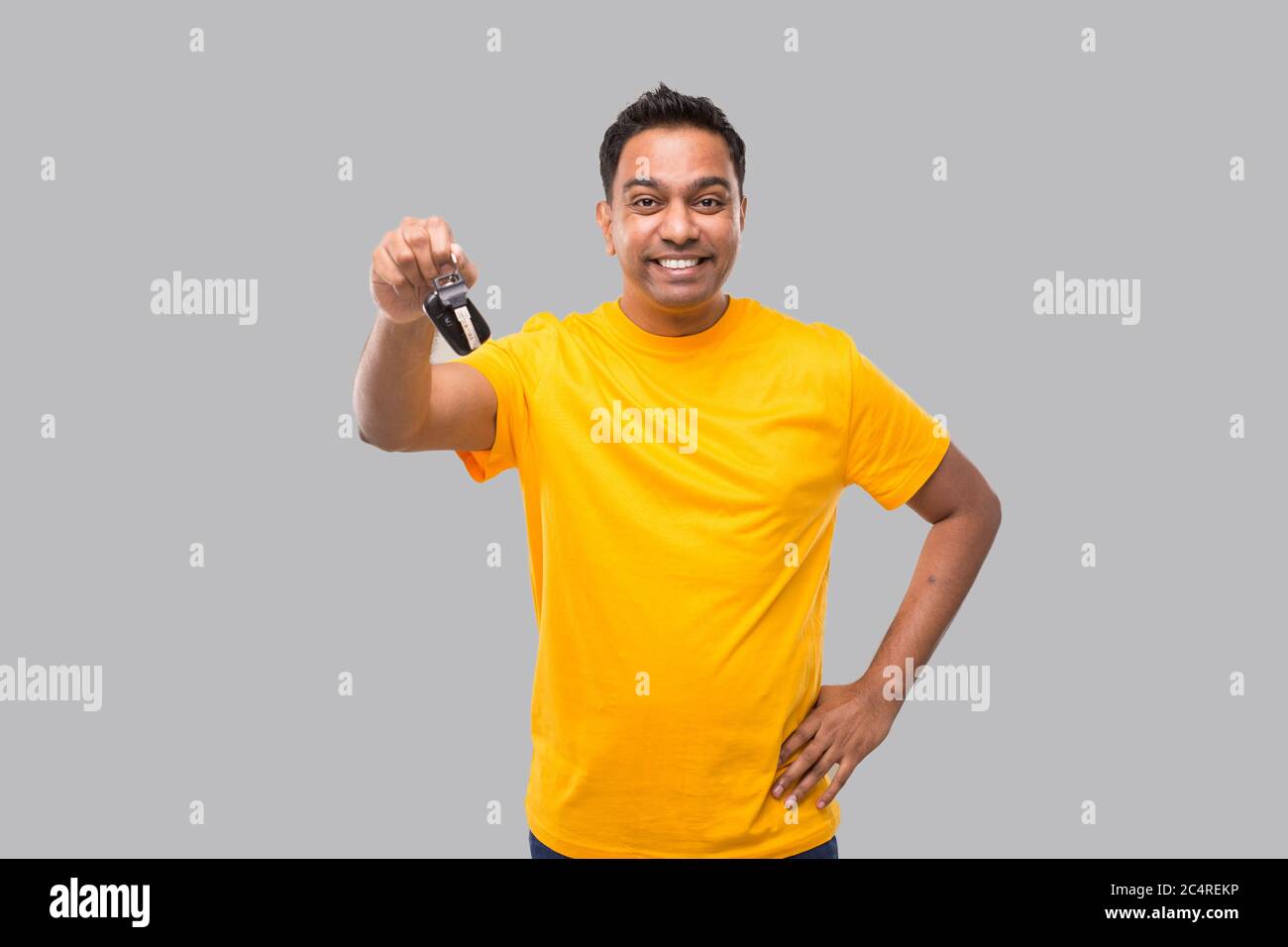 Indian Man Smilling Showing Car Keys Isolated. Driver Stock Photo