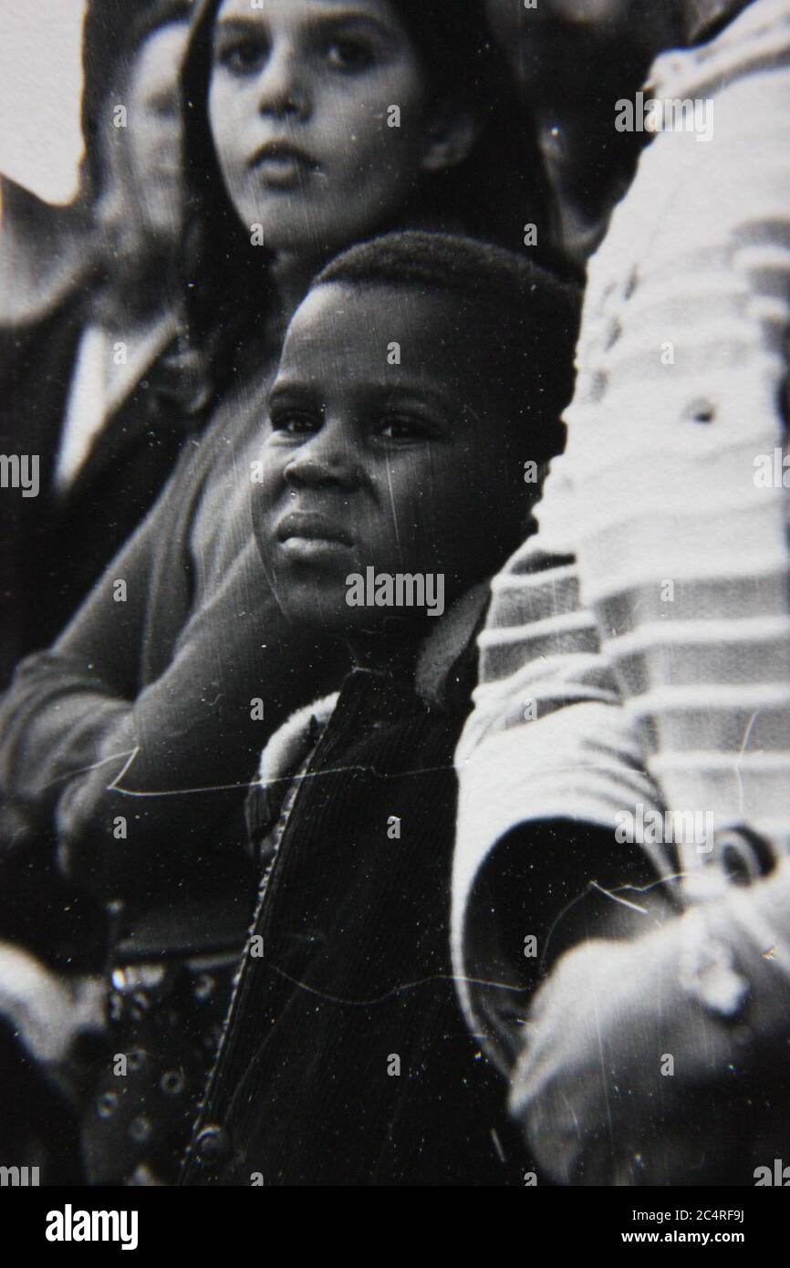 Fine 70s vintage black and white photography of a boy watching a parade in downtown Chicago. Stock Photo