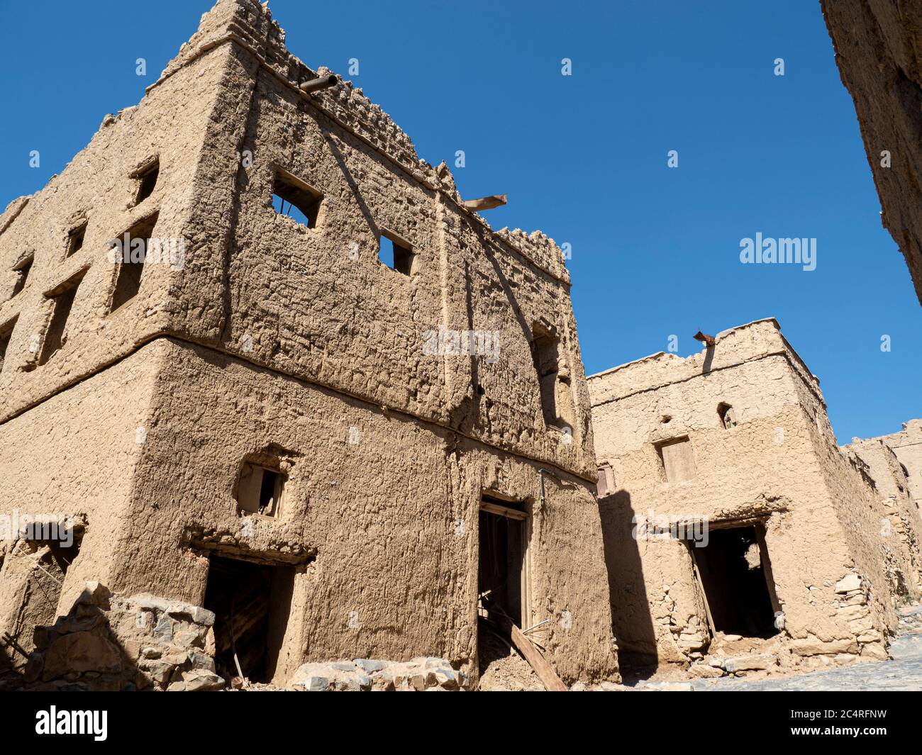 Exterior view of a mostly abandoned mud construction houses in Bait Al
