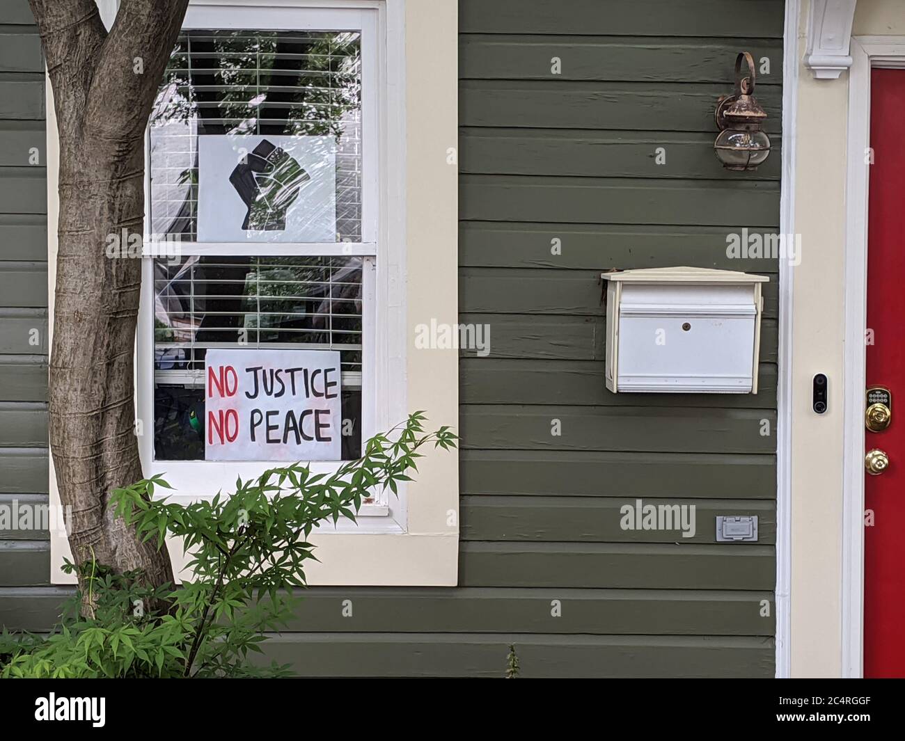 Sign in a window proclaims 'No Justice No Peace'  on a home in the Shaw neighborhood of Washington, DC. Stock Photo