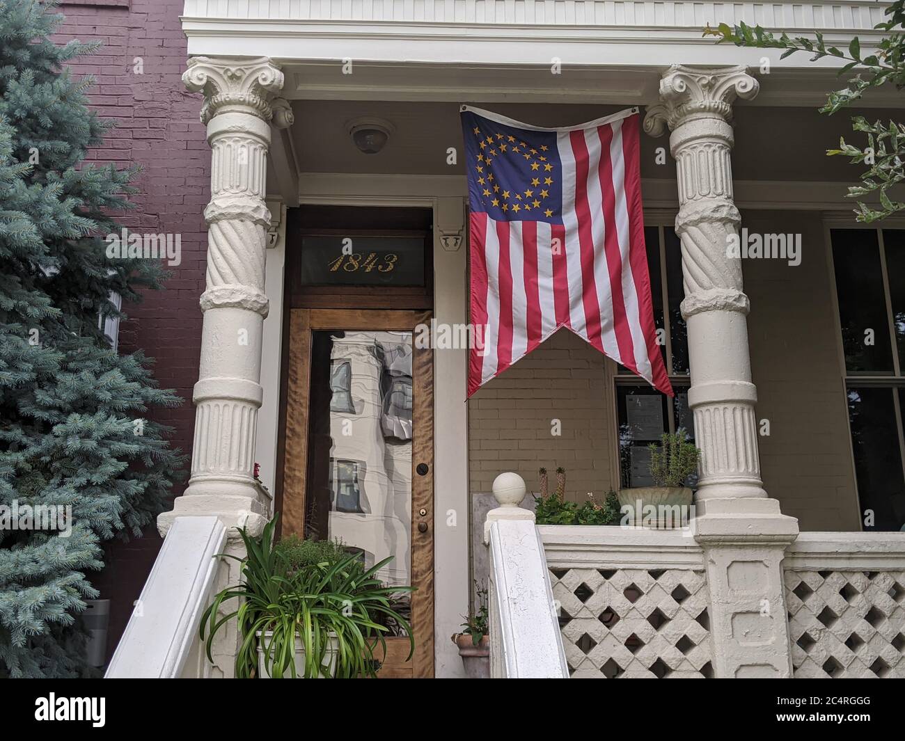 A U.S. cavalry guidon hangs on a porch on 12th street NW, In Shaw. Stock Photo