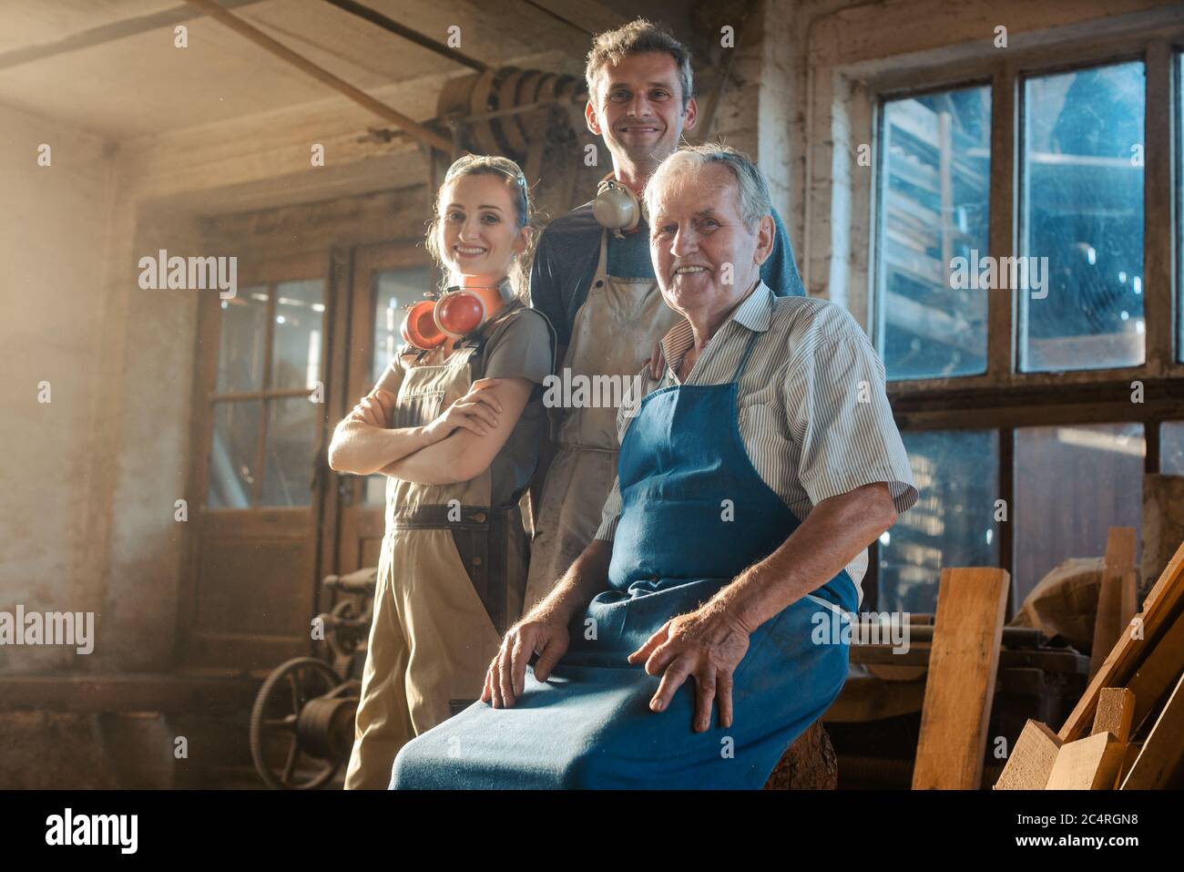 Generations of carpenters in their family business workshop Stock Photo