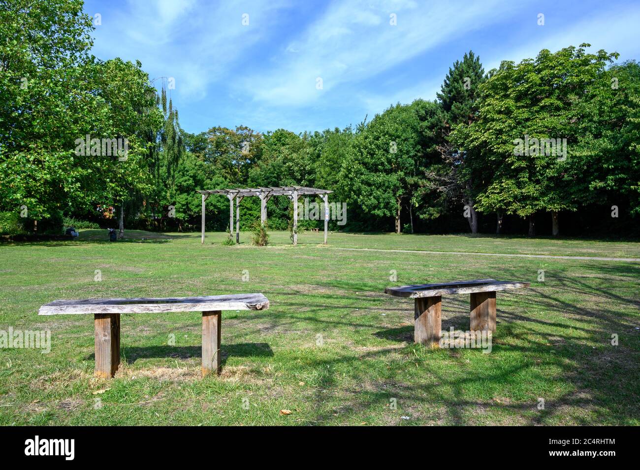 College Green in Bromley (London), Kent. This open space near the center of Bromley has grass, flowers and trees. Photo shows seats and a pergola. Stock Photo