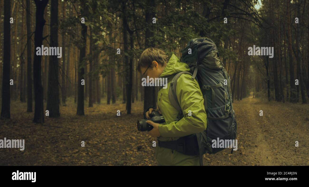 Photographer take a pictures sunrise in forest during hiking Stock Photo