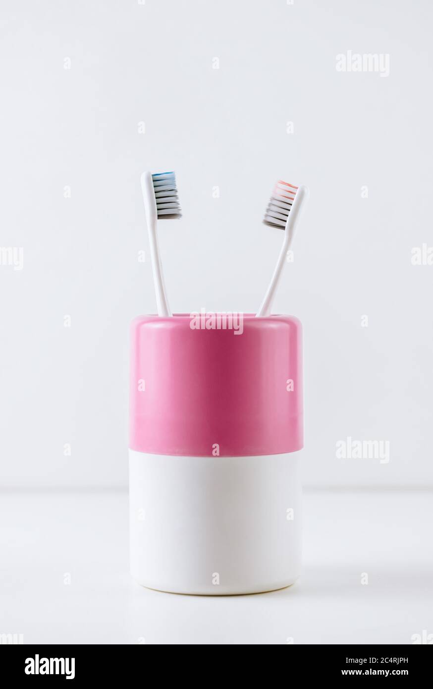 Different types of toothbrushes in a white cup Stock Photo Alamy