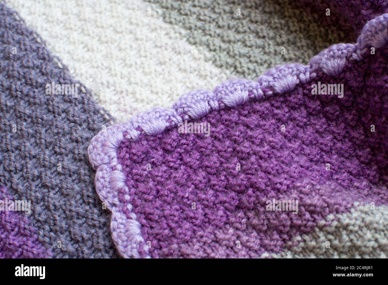 Purple, gray, and white knitted blanket Stock Photo Alamy