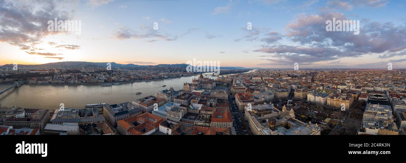 Panoramic Aerial drone shot of Hungarian Parliament Kossuth Square by Danube river in Budapest sunset Stock Photo