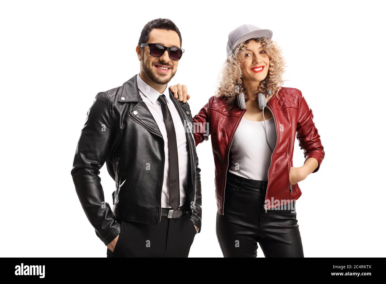 Trendy young man and woman in leather jackets isolated on white ...