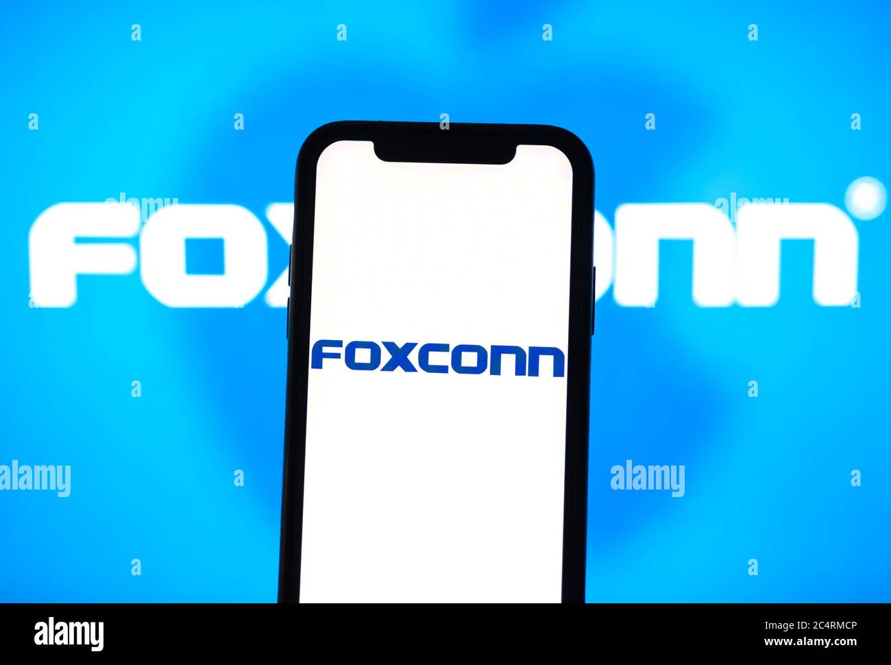 Foxconn logo on the smartphone screen. Stock Photo