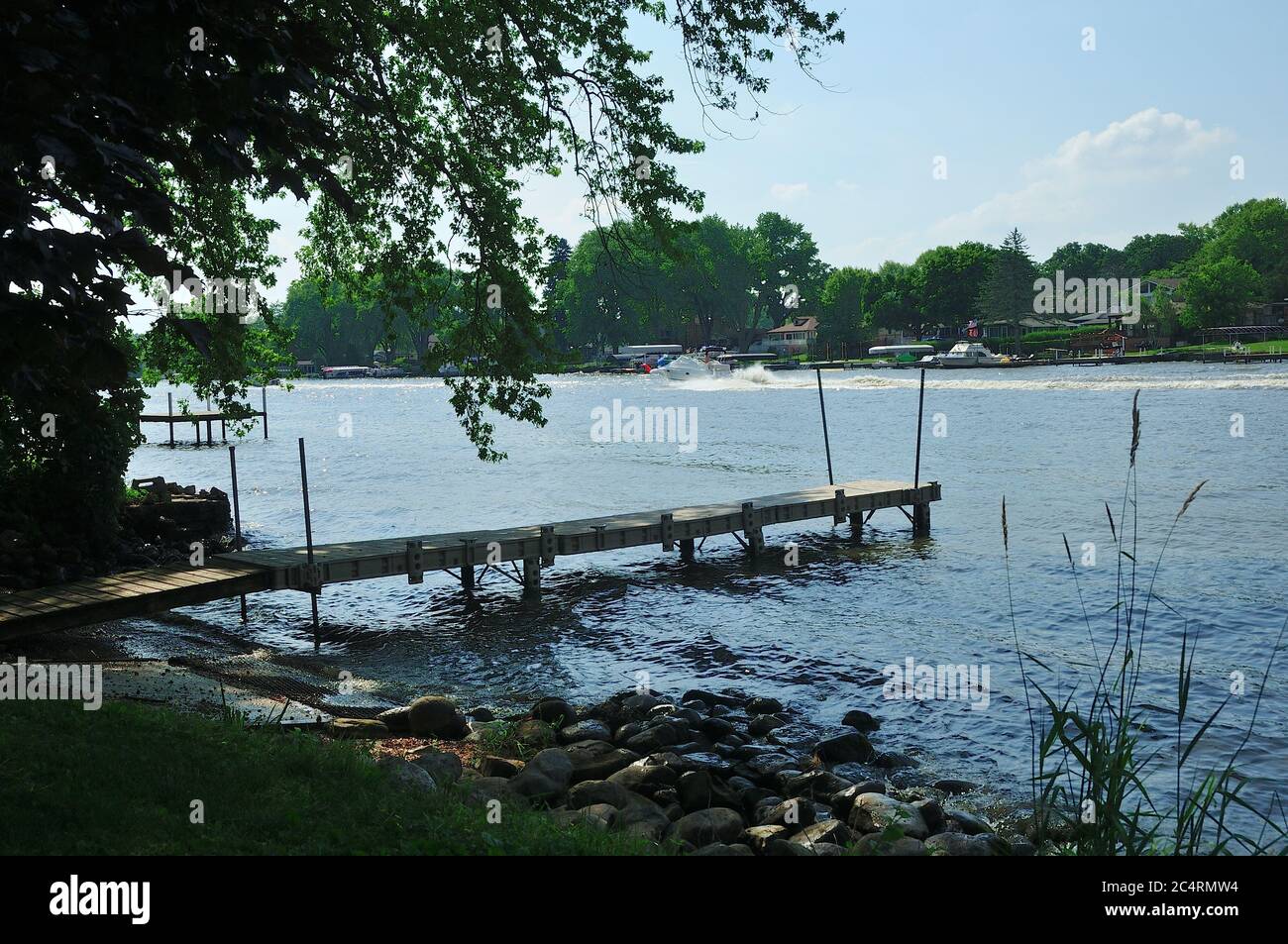 A dock jutting out into the Fox River in Northern Illinois, USA. Stock Photo