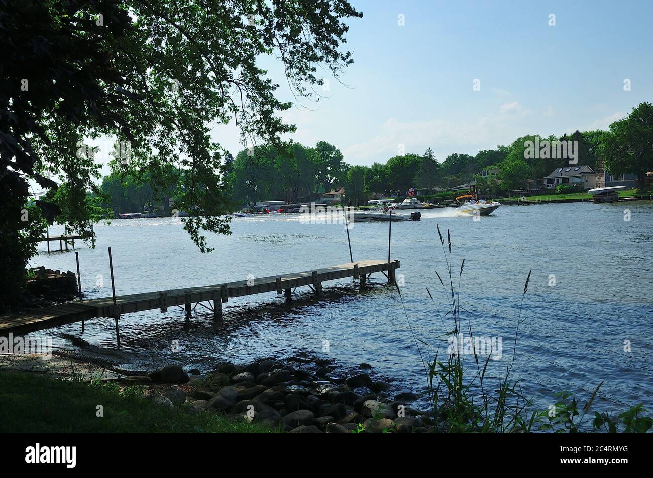 A dock jutting out into the Fox River in Northern Illinois, USA. Stock Photo