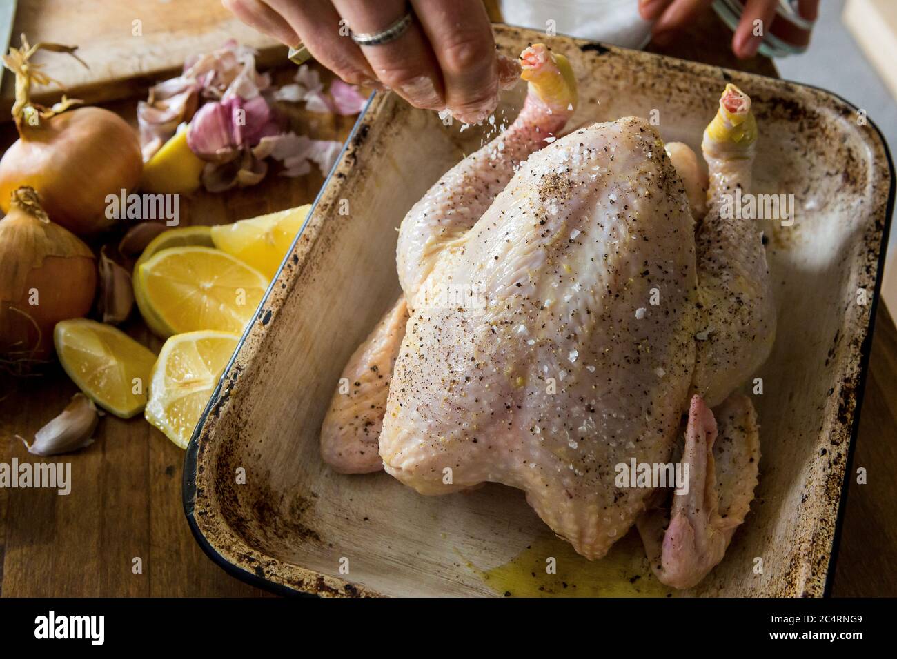 Prepping lemon and garlic chicken recipe for roasting Stock Photo