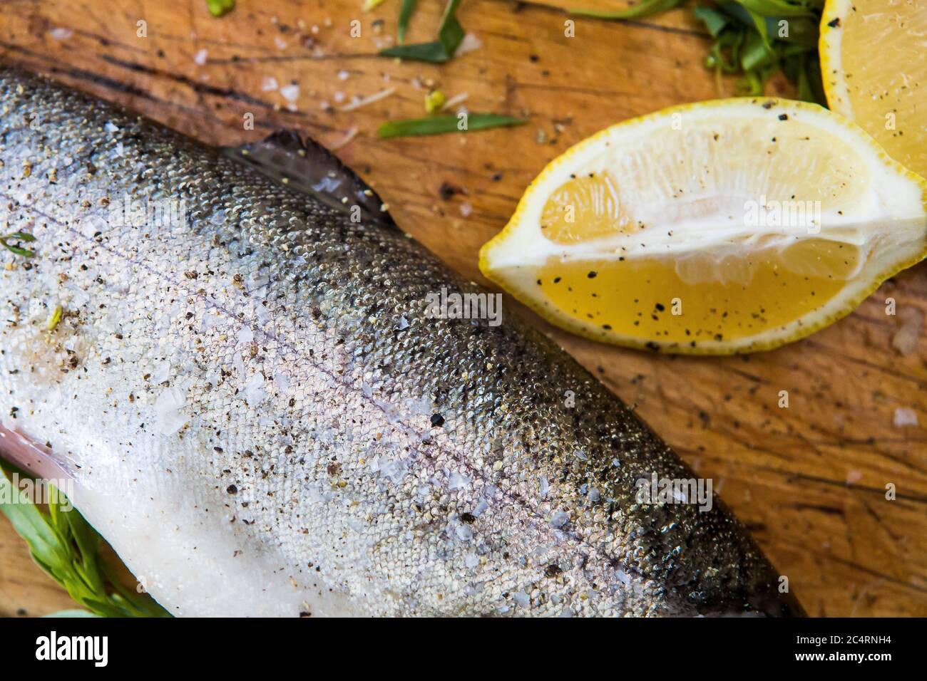 Prepping trout stuffed with tarragon recipe Stock Photo