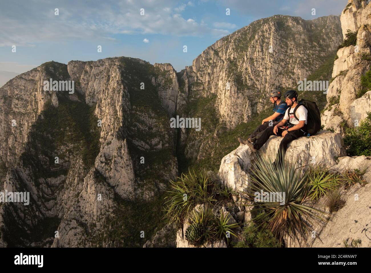 Two friends sitting on a rock in a high point at La Huasteca Stock Photo