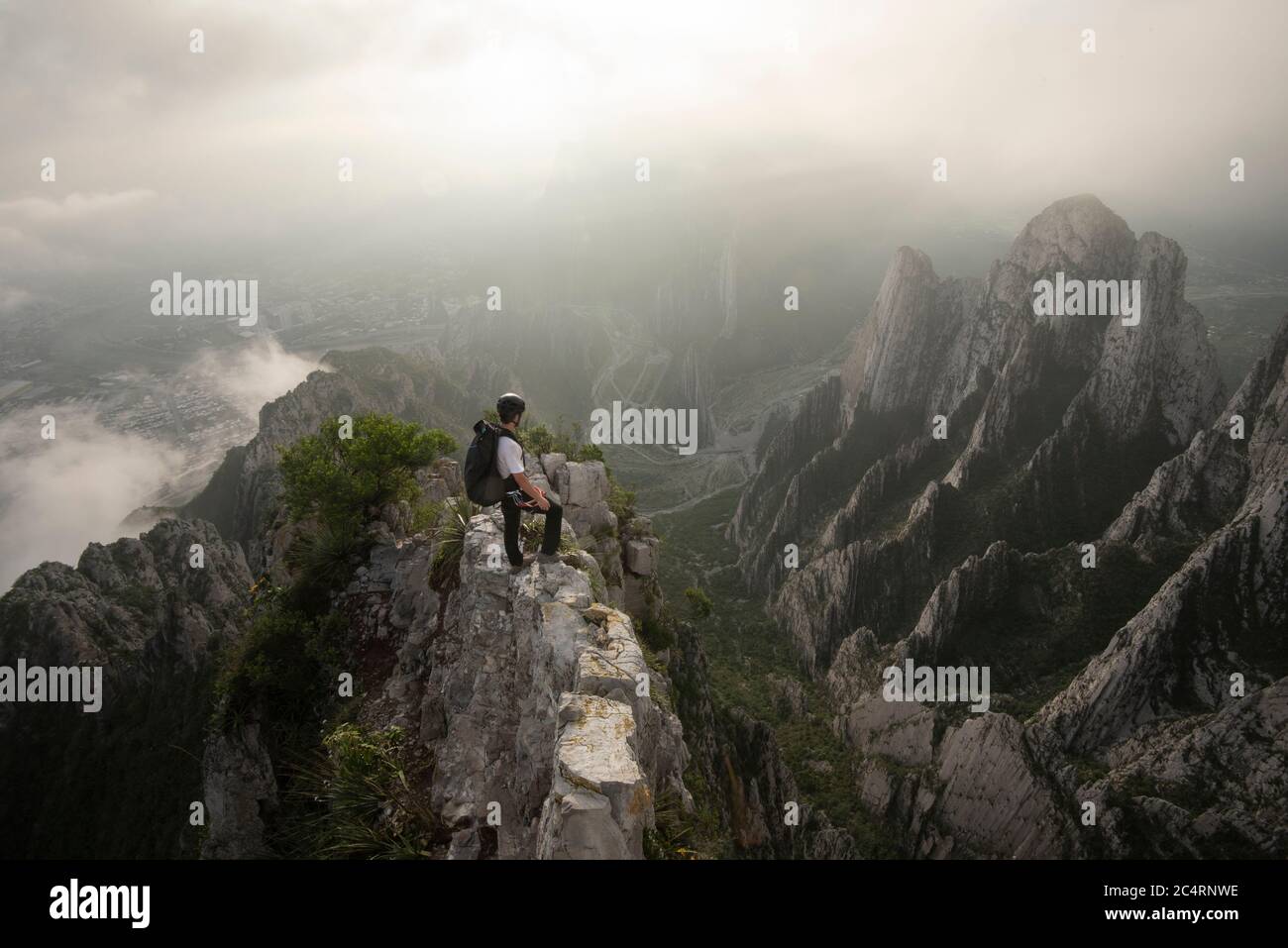 One man standing on a narrow edge at a high area in La Huasteca Stock Photo