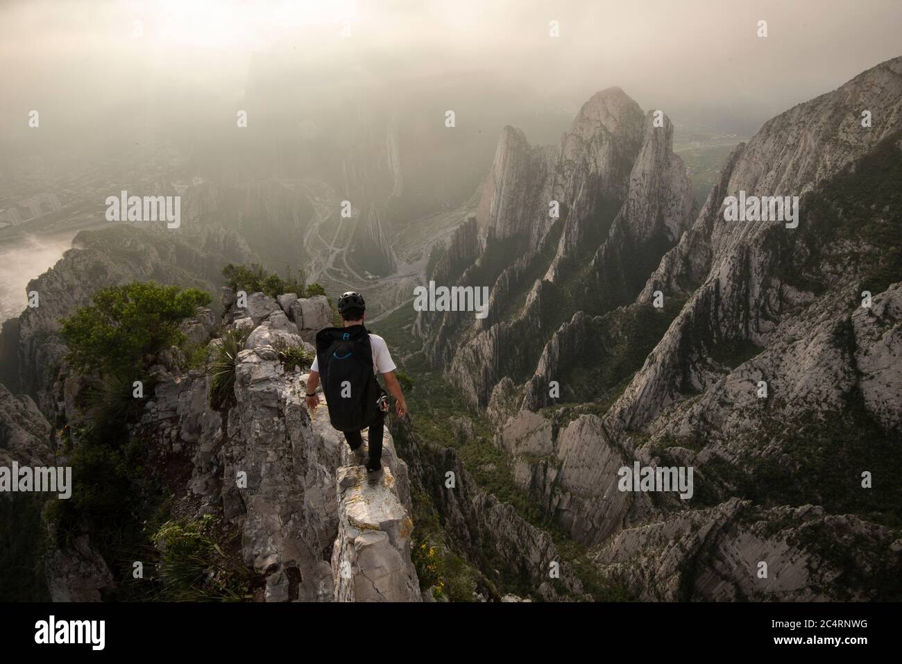 One man walking on a narrow edge on a high exposed area in La Huasteca Stock Photo