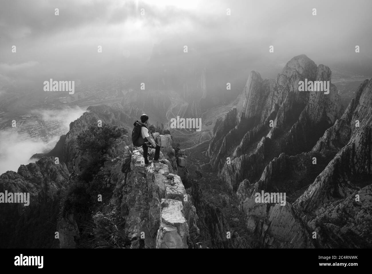 One man standing on a narrow edge at a high area in La Huasteca Stock Photo