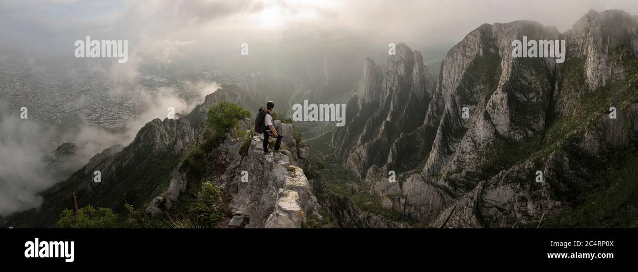 One man standing on a narrow edge at a high area in La Huasteca Stock Photo