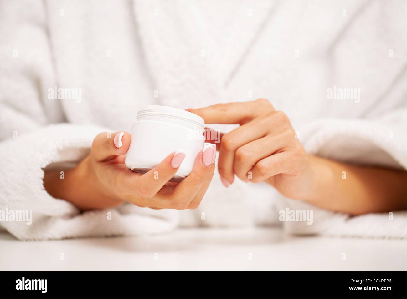 Hand skin care, woman applies moisturizer on soft silky skin Stock Photo