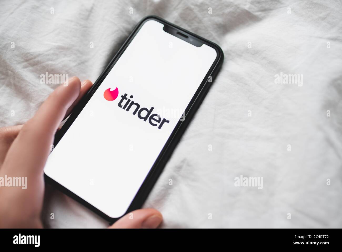 Tinder App Logo On The Smartphone Screen In Woman Hands Stock Photo Alamy