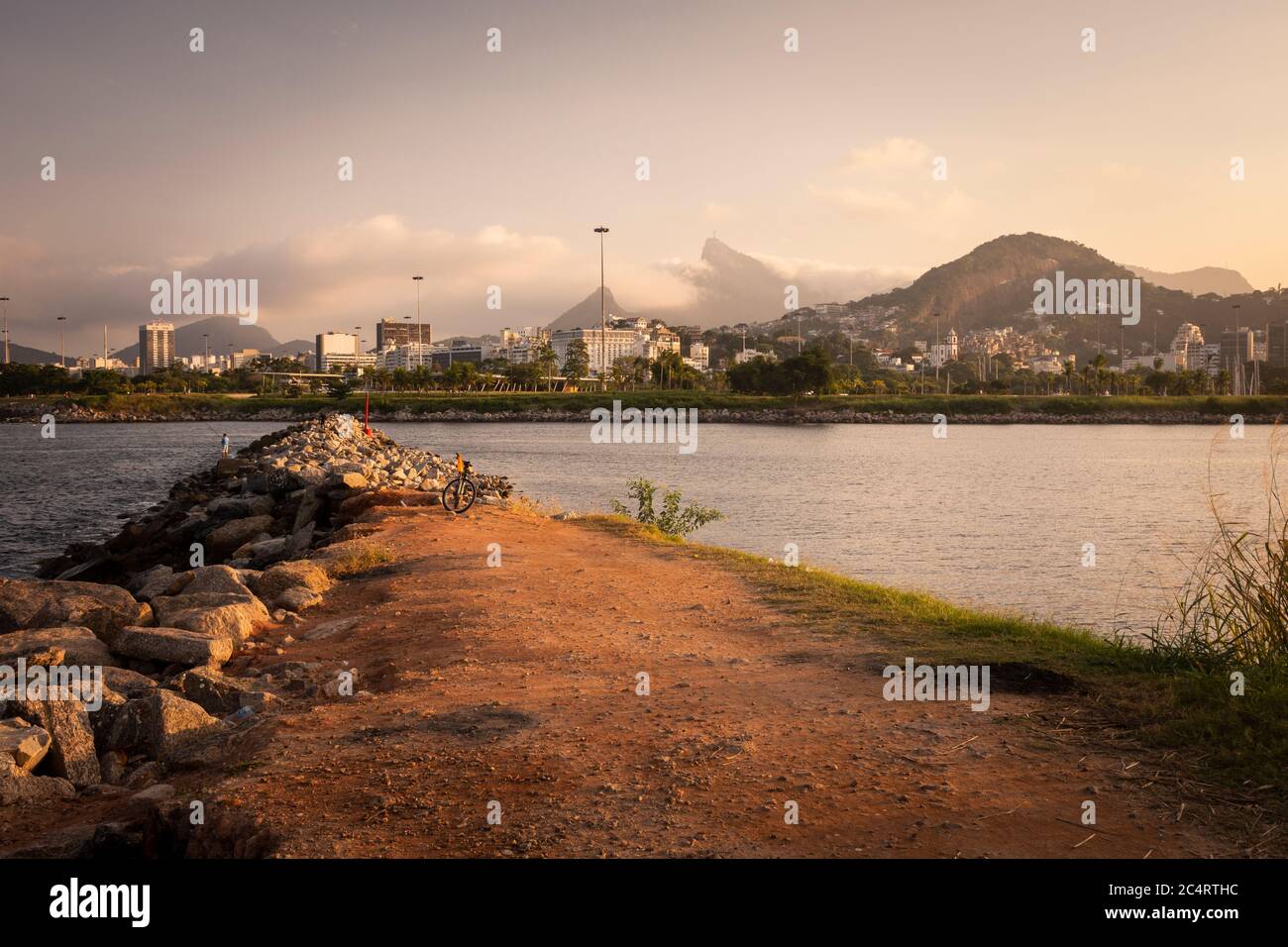 Beautiful sunset view to waterbreak by the ocean and city landscape on the back, Rio de Janeiro, Brazil Stock Photo