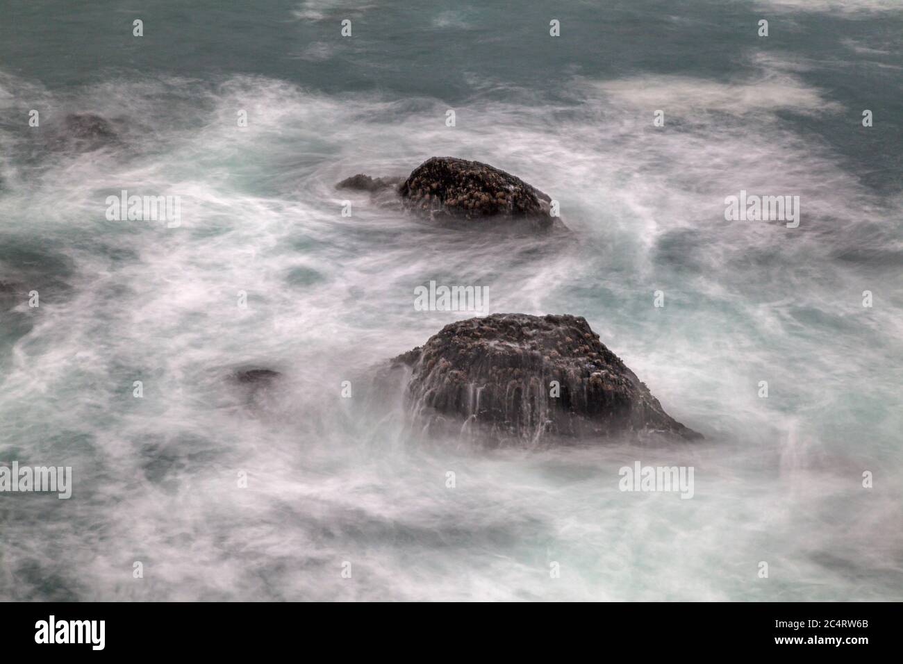 Waves crashing on rocks in Mendocino, California. Stock Photo