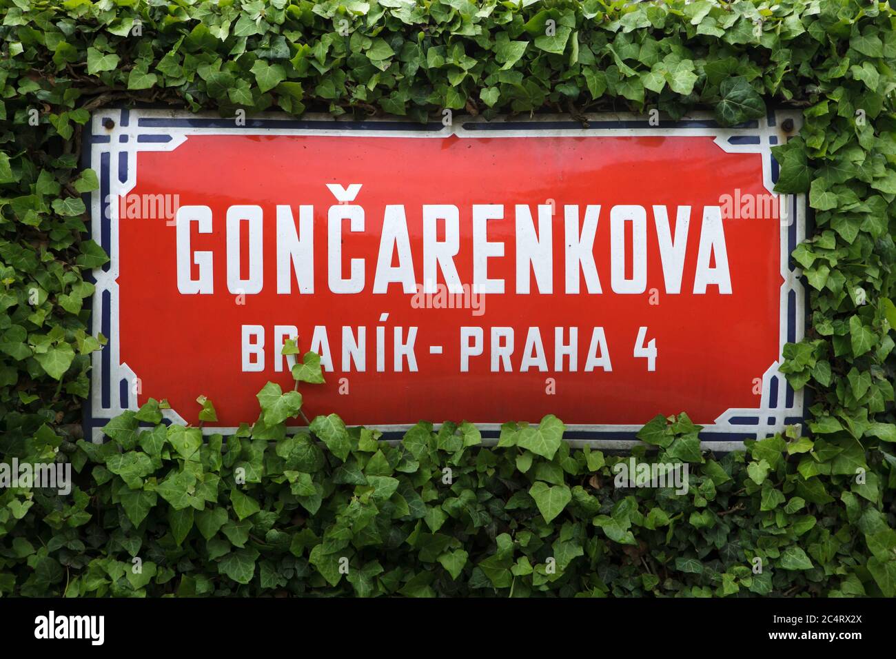 Gončarenkova Street. Traditional red street sign in Braník district in Prague, Czech Republic. The street is named after Soviet lieutenant Ivan Goncharenko (also spelled Ivan Gončarenko) who was a commander of the first Soviet tank T-34 which entered into Prague at the morning on 9 May 1945. The tank was hit by the Nazi Germans and Ivan Goncharenko died at age 24 near the Manes Bridge (Mánesův Bridge), becoming the first and probably the only Soviet soldier who died in Prague during the liberation of the capital of Czechoslovakia during World War II. Stock Photo