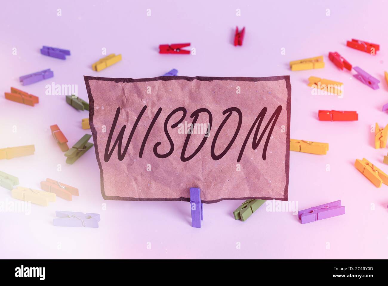 Word writing text Wisdom. Business photo showcasing body of knowledge and principles that develops within specific period Colored clothespin papers em Stock Photo