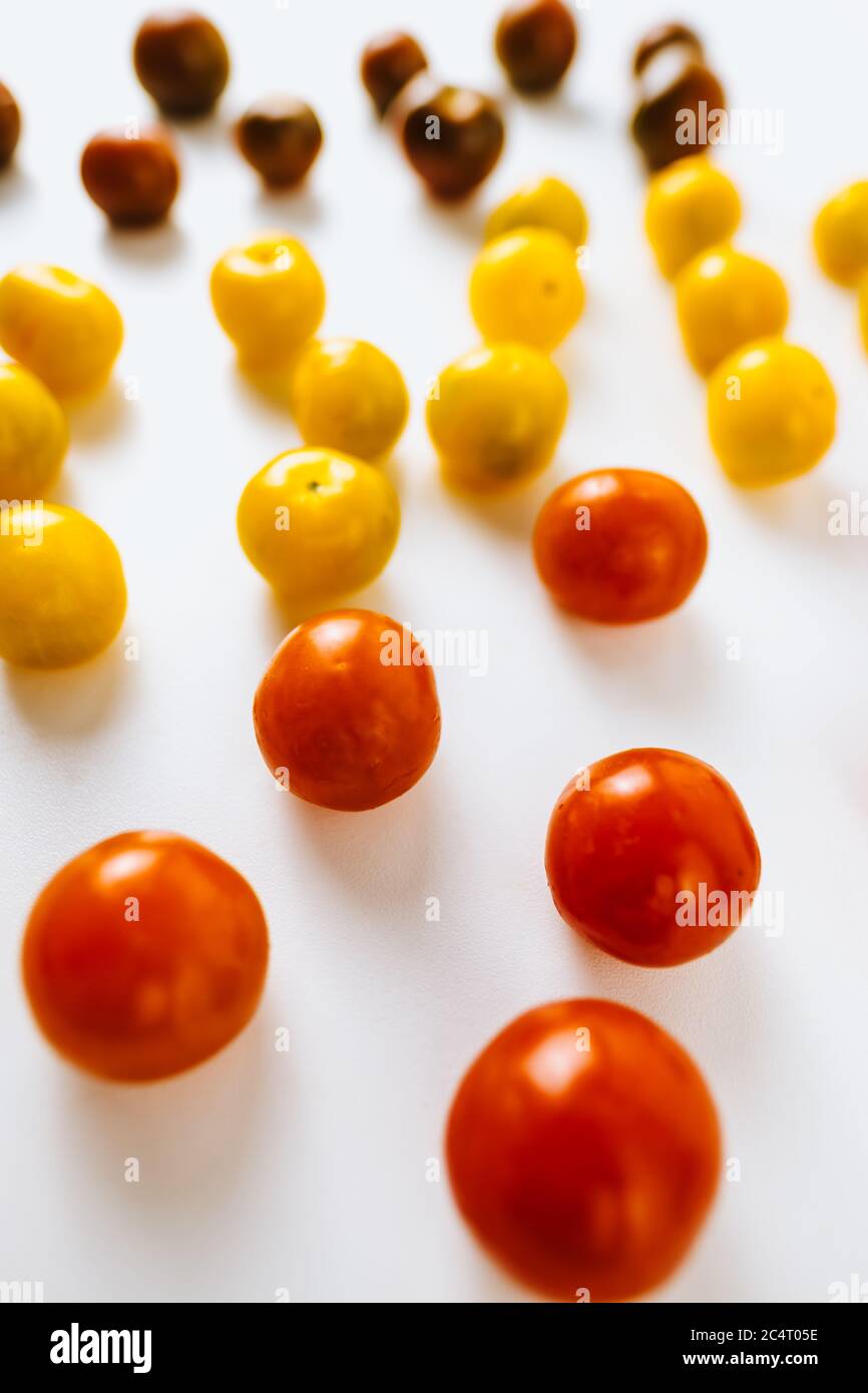 Varieties of cherry tomatoes in line isolated Stock Photo - Alamy