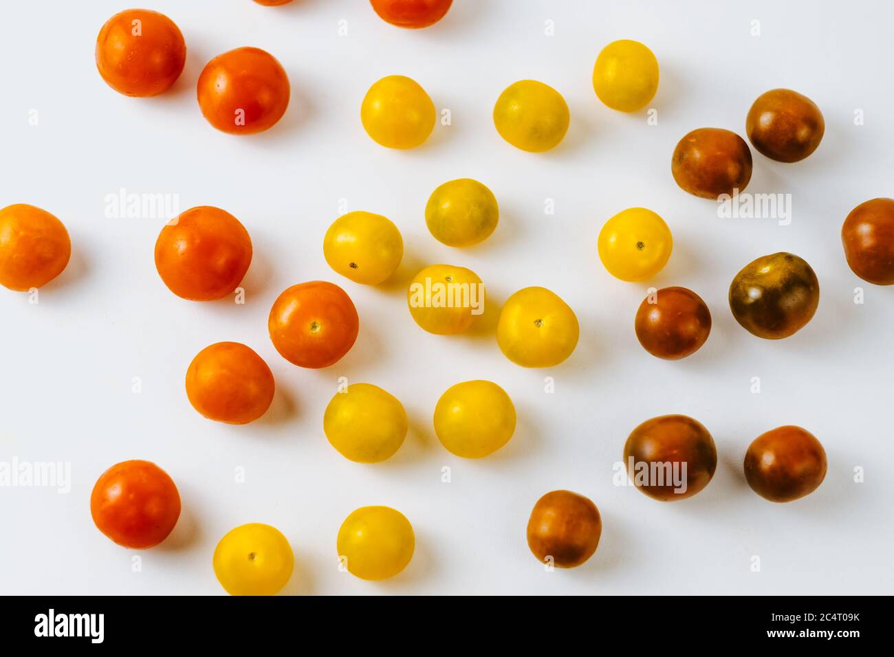 Varieties of cherry tomatoes in line isolated Stock Photo Alamy
