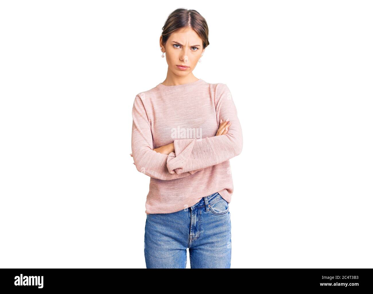 Beautiful caucasian woman with blonde hair wearing casual winter sweater skeptic and nervous, disapproving expression on face with crossed arms. negat Stock Photo