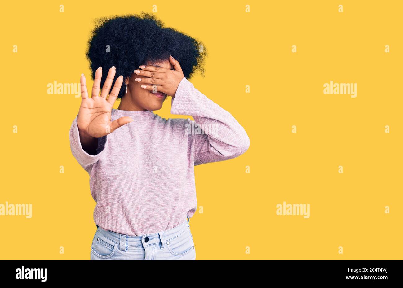 Young african american girl wearing casual clothes covering eyes with hands and doing stop gesture with sad and fear expression. embarrassed and negat Stock Photo