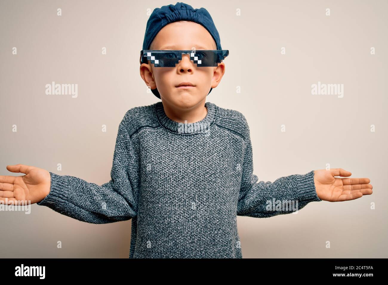Young little caucasian kid wearing meme thug life glasses over