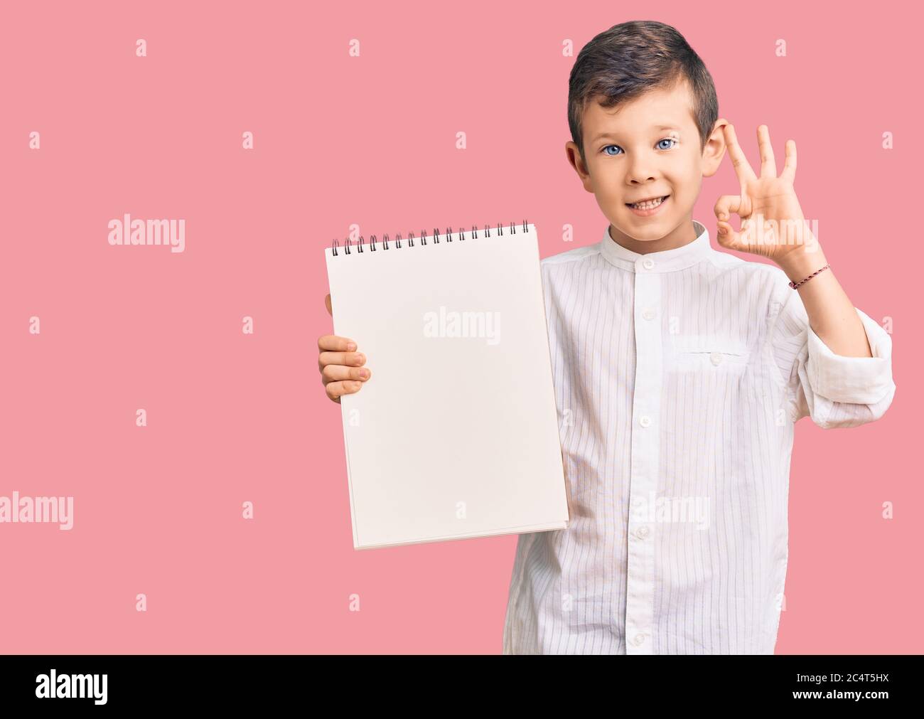 Ok Sign Kid Cute blond kid holding notebook doing ok sign with fingers, smiling ...