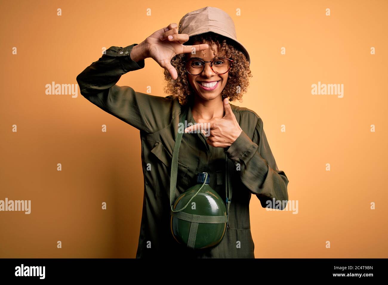 Young african american tourist woman on vacation wearing explorer hat ...