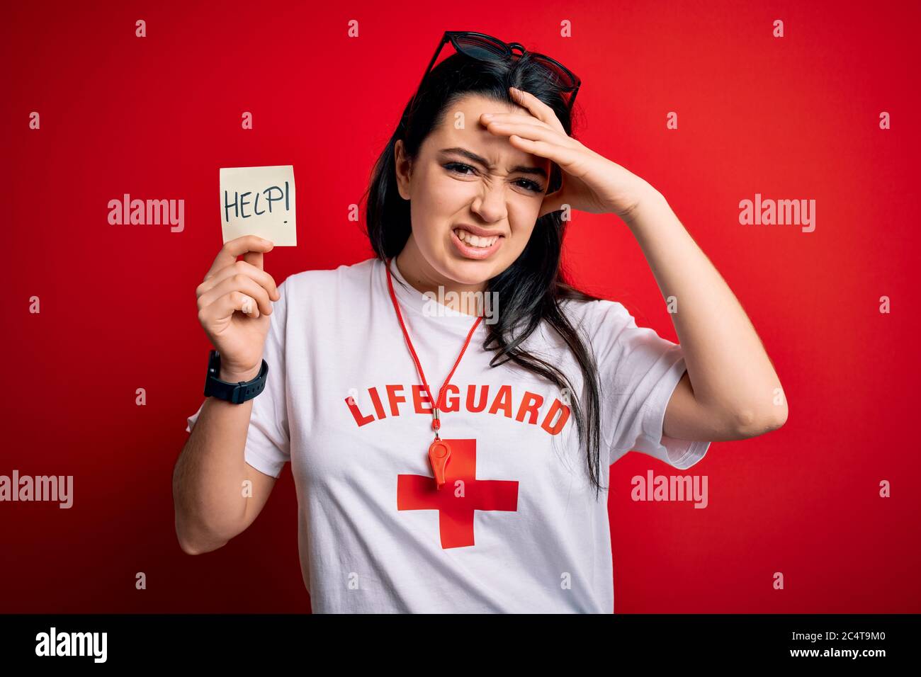 Young lifeguard woman holding paper note with help word over red ...