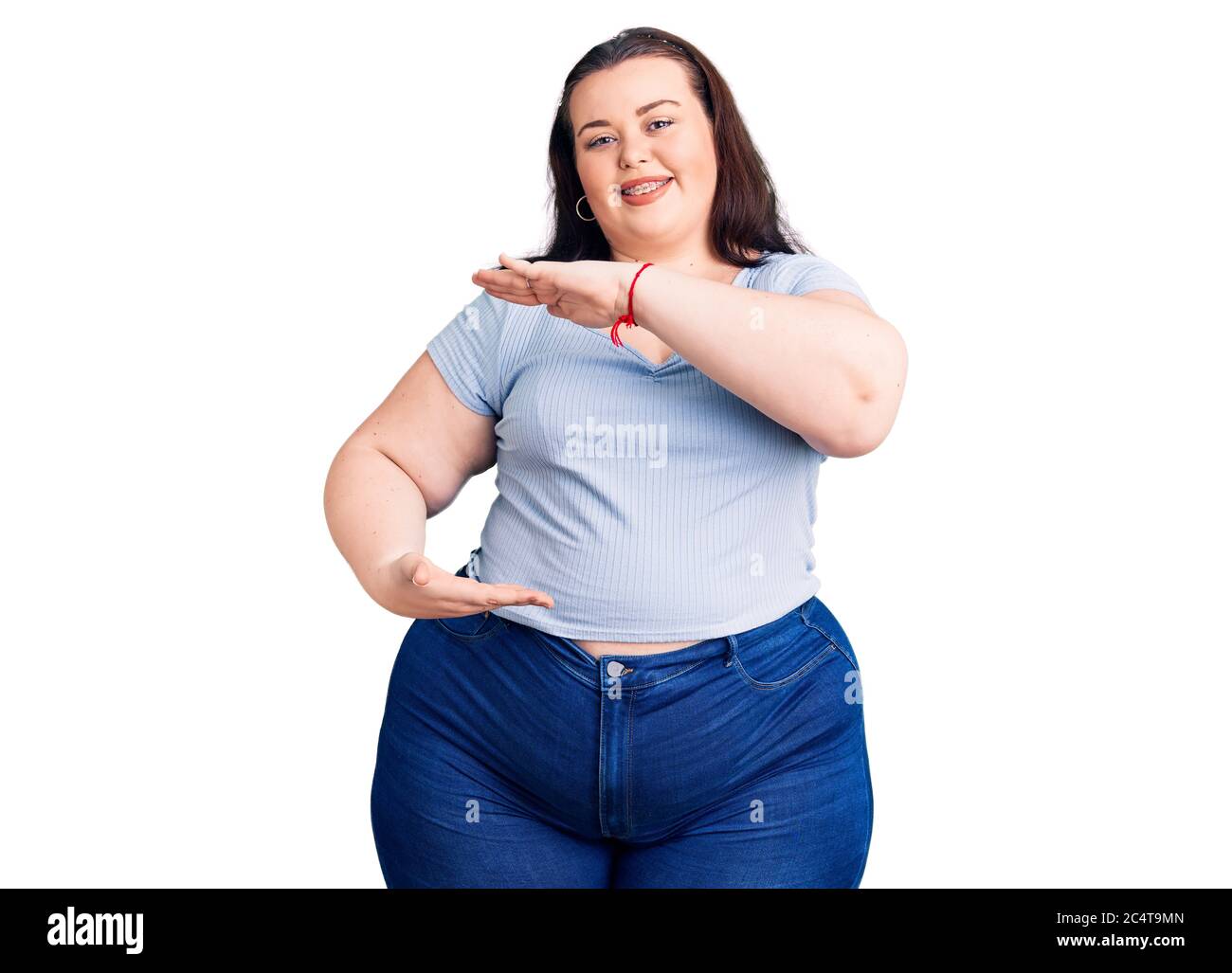 Young plus size woman wearing casual clothes gesturing with hands