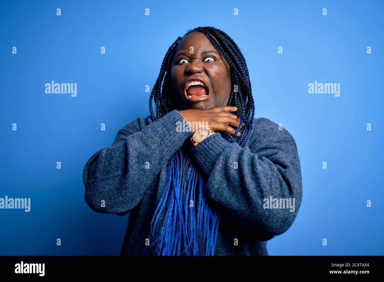 African american plus size woman with braids wearing casual sweater ...