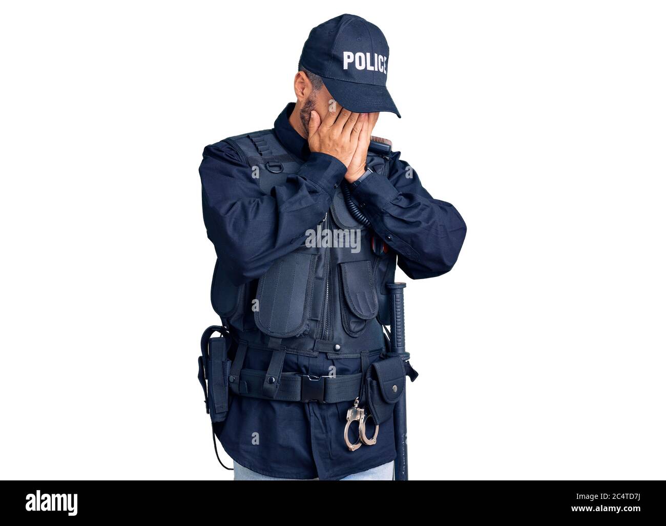 Young hispanic man wearing police uniform with sad expression covering face with hands while crying. depression concept. Stock Photo