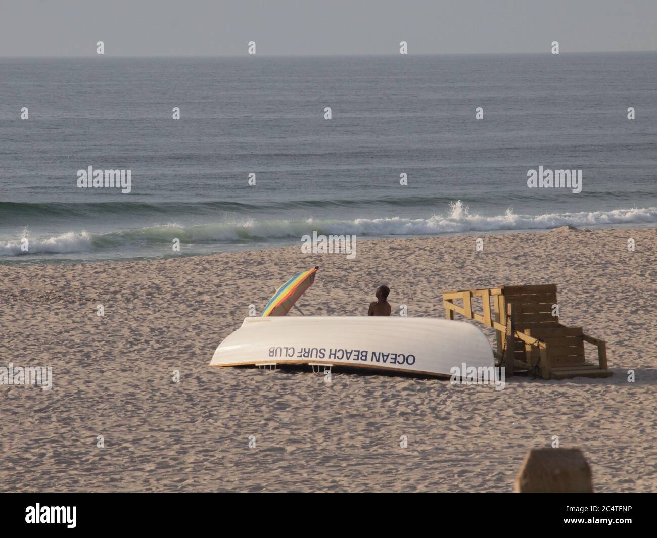 Muslim worshiper facing east on beach along atlantic ocean hires stock
