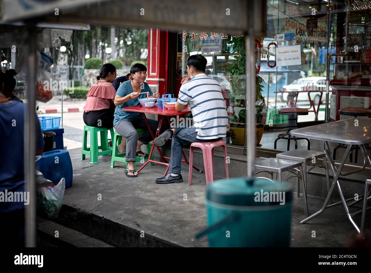 Thailand people eating outside on the street pavement Southeast Asia Stock Photo