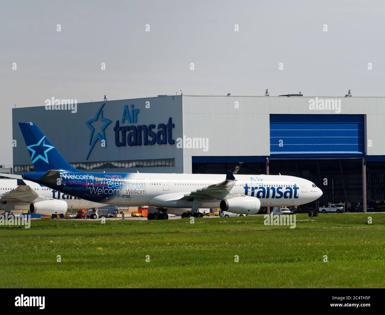 Air Transat Airbus A330-343 parked at the hanger at the Pierre Elliott Trudeau International airport in Dorval, Quebec Stock Photo