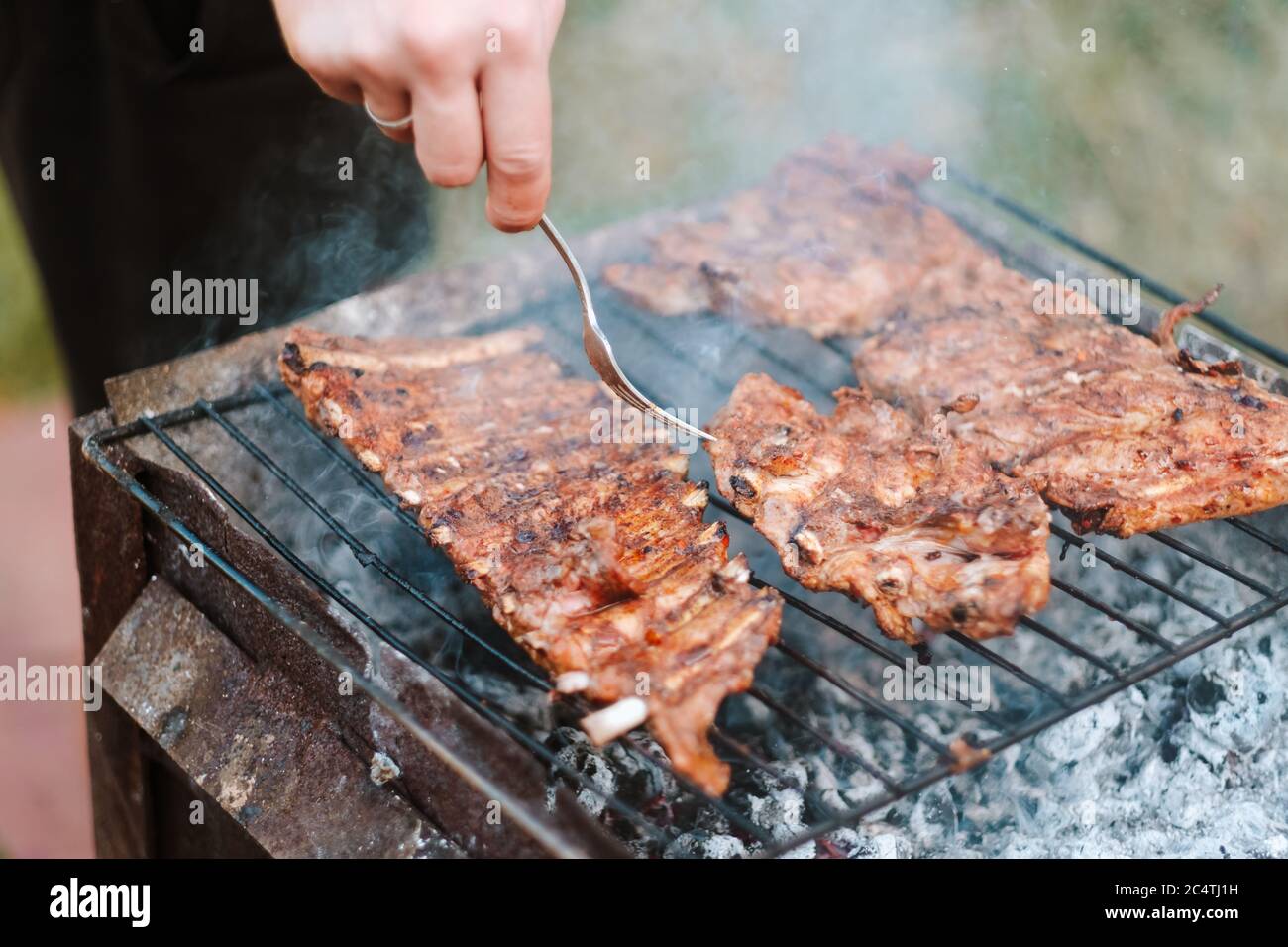 Cooking pork ribs on the grill Stock Photo Alamy