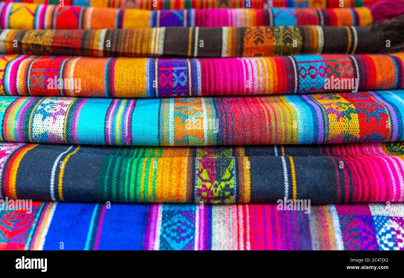The traditional andean fabrics sold on the handicrafts market of Otavalo, Ecuador. Stock Photo