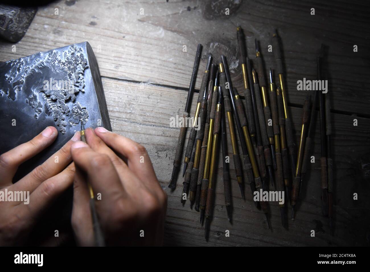 Beijing, China's Anhui Province. 23rd June, 2020. A worker carves an inkstone at a local inkstone manufacturer in Shexian County, east China's Anhui Province, June 23, 2020. Credit: Liu Junxi/Xinhua/Alamy Live News Stock Photo