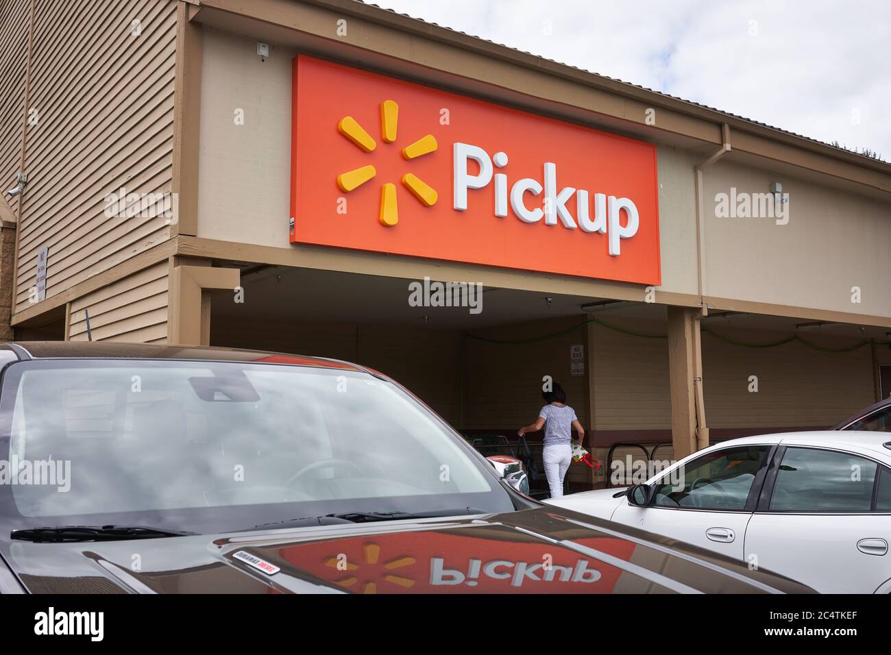 The Pickup sign is seen at a Walmart neighborhood market in West Linn, Oregon. The COVID-19 pandemic prompts an ongoing spike in online grocery orders. Stock Photo