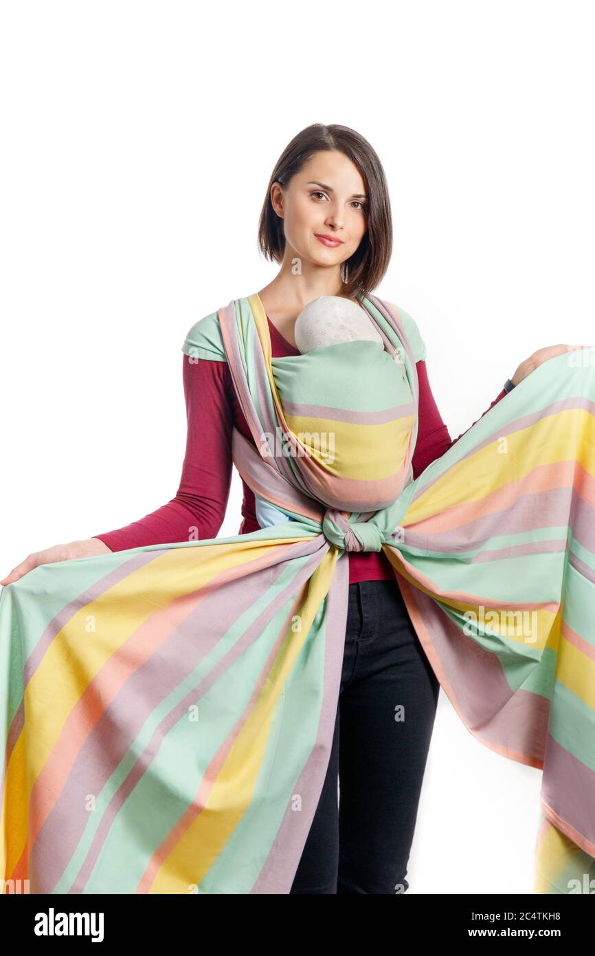 Baby wearing beautiful young mother with baby in woven wrap sling carrier. Free hands and active