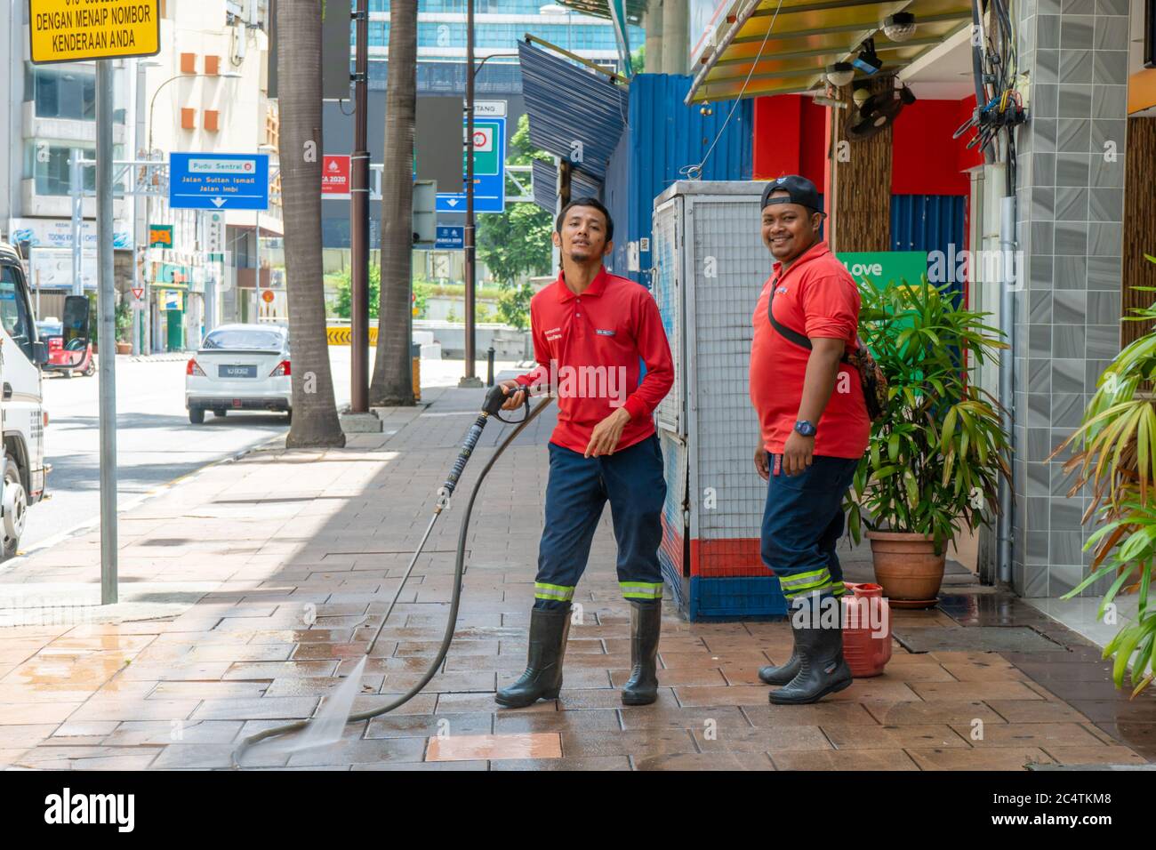 Utility workers in Malaysia wash the streets of the city. Malaysia Utilities Stock Photo Alamy