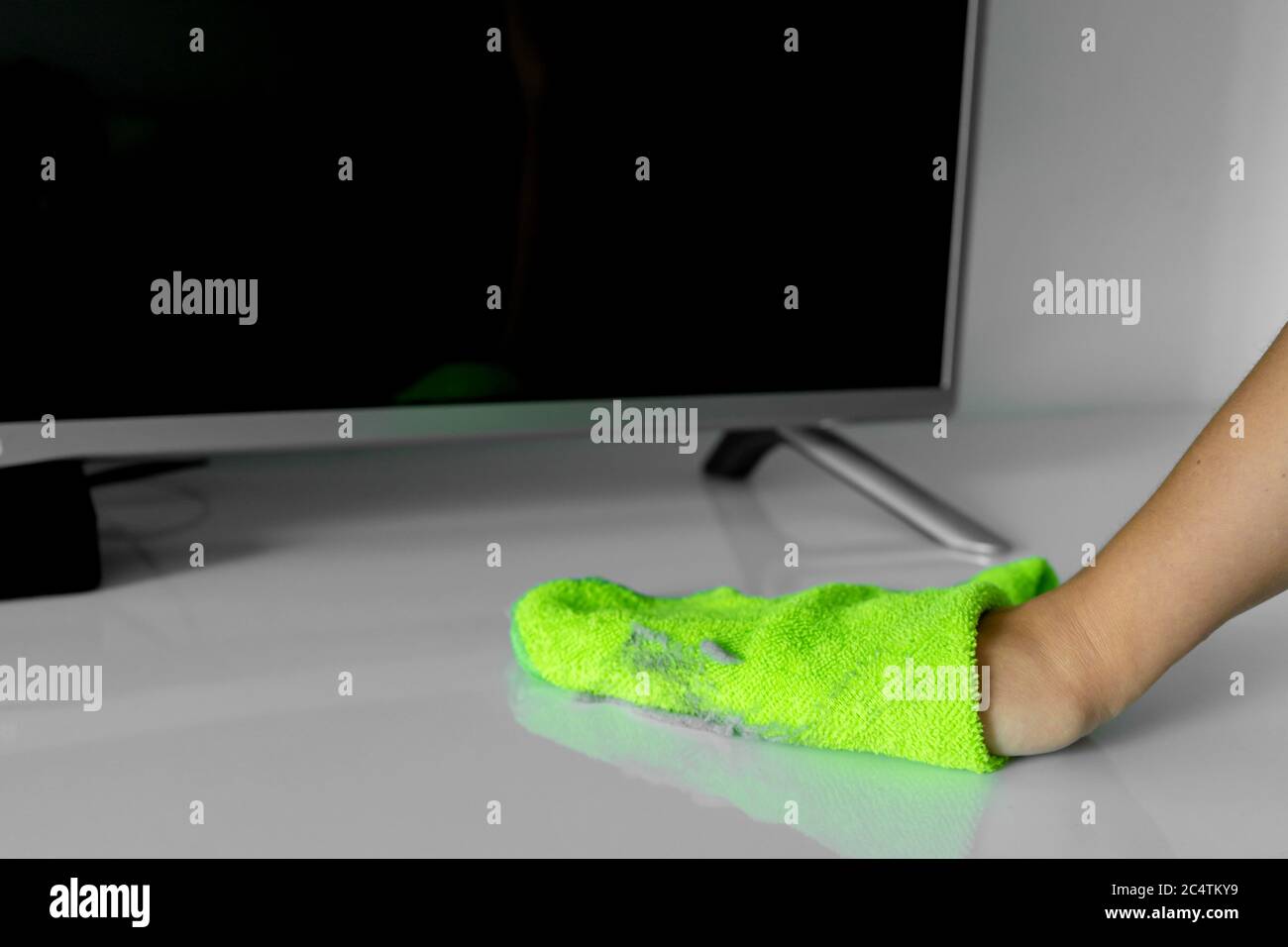 Cleaning the house. Wipe off the dust with a green rag from a dirty ...